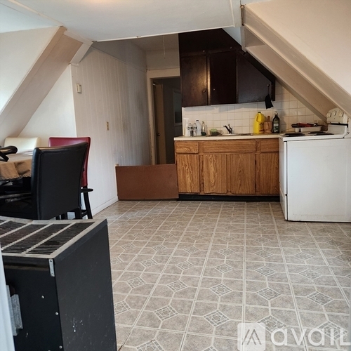 A kitchen with a white fridge, white stove, and a black oven.