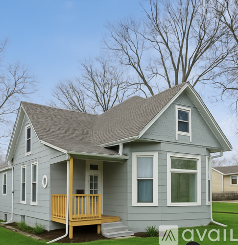 A house with a grey exterior and a yellow porch.