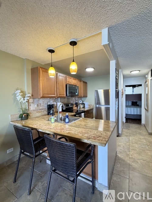 A kitchen with a table and chairs.