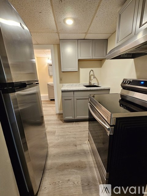 A kitchen with a stainless steel refrigerator and oven.