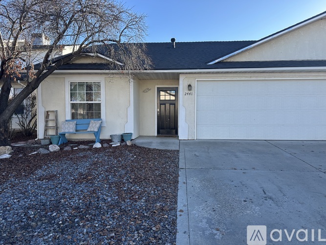 A house with a garage and a driveway in front.
