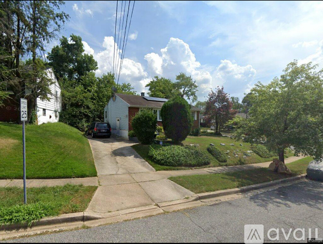 A residential street with houses and trees.
