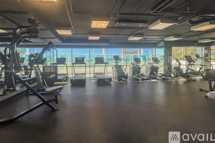 A gym with treadmills, elliptical machines, and other cardio equipment.