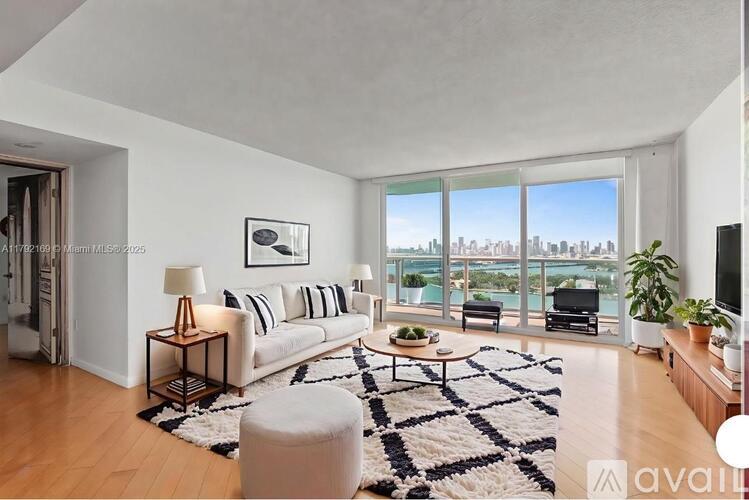 A living room with a large window overlooking the city.