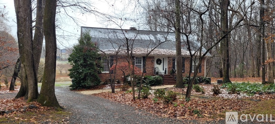 A house surrounded by trees in a wooded area.