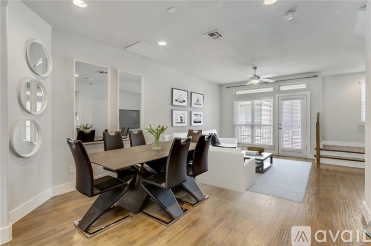 A modern dining room with a large table and chairs.