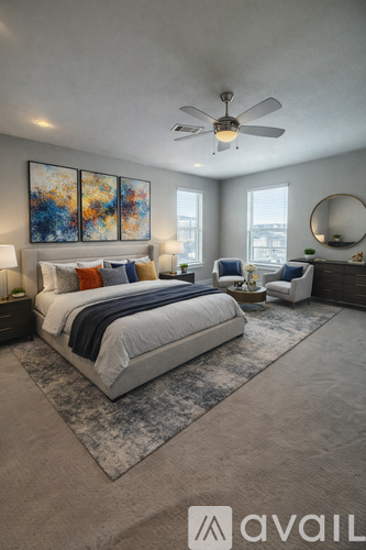 A bedroom with a large bed and a ceiling fan.