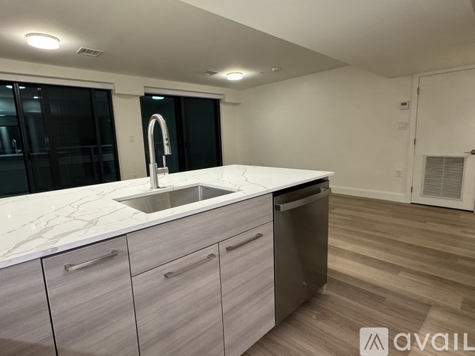 A kitchen with a sink and a dishwasher.