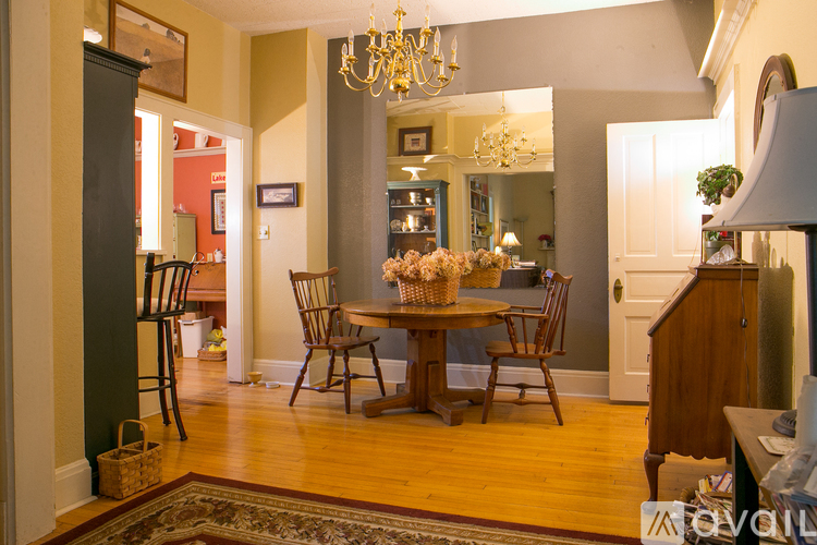 A dining room with a wooden table and chairs.
