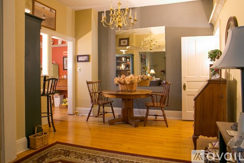 A dining room with a wooden table and chairs.