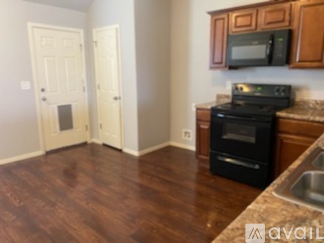 A kitchen with a black oven and microwave.