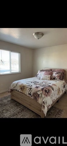 A bedroom with a bed and a window.