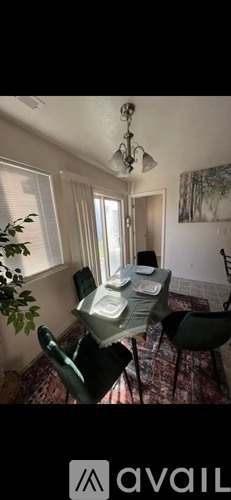 A dining room with a table set for four.