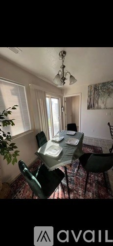 A dining room with a table set for four.
