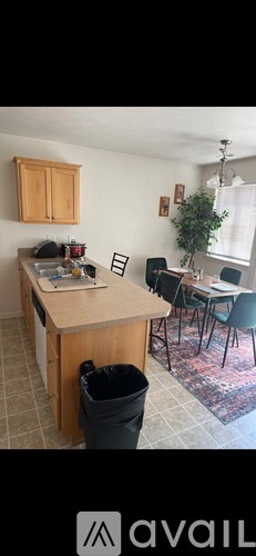 A kitchen with a table and chairs.