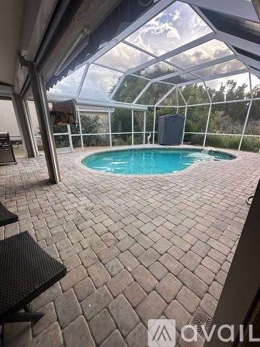 A patio with a pool and a table.