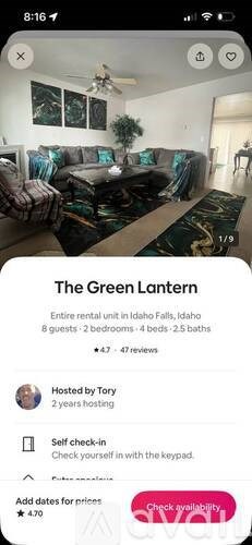 A room with a couch, a ceiling fan, and a plant.