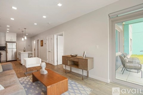 A modern living room with a white chair and a wooden coffee table.