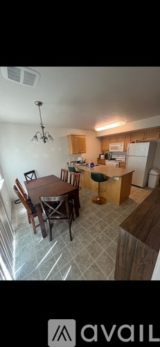 A kitchen with a table and chairs in the middle of the room.