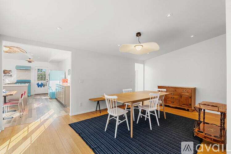 A dining room with a table and chairs.