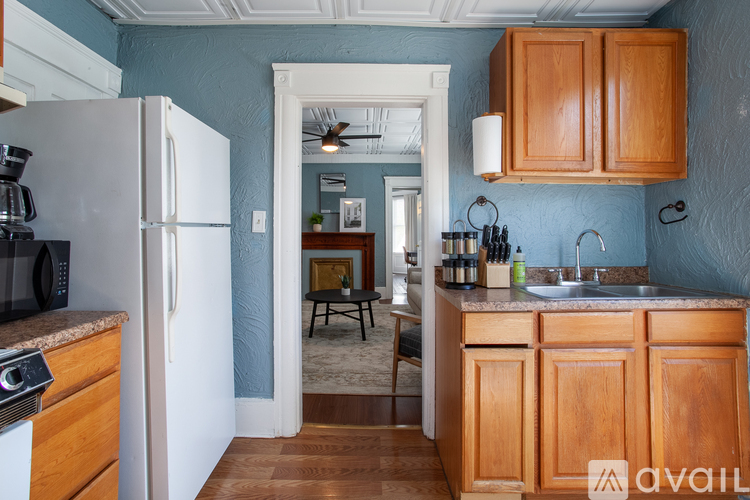 A kitchen with wooden cabinets and a white refrigerator.