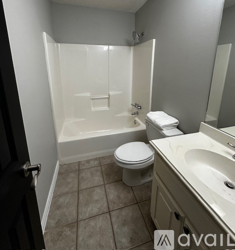 A bathroom with a toilet, sink, and bathtub.