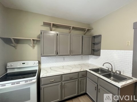 A kitchen with a white oven and a white sink.