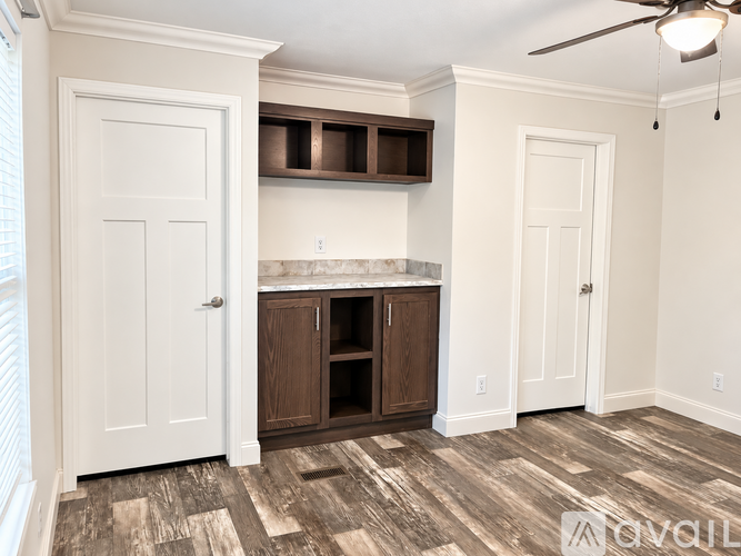 A room with a white wall and a wooden floor.