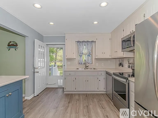 A kitchen with a blue cabinet and stainless steel appliances.