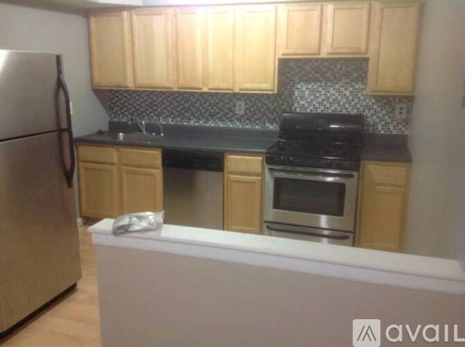A kitchen with wooden cabinets and a black stove top oven.