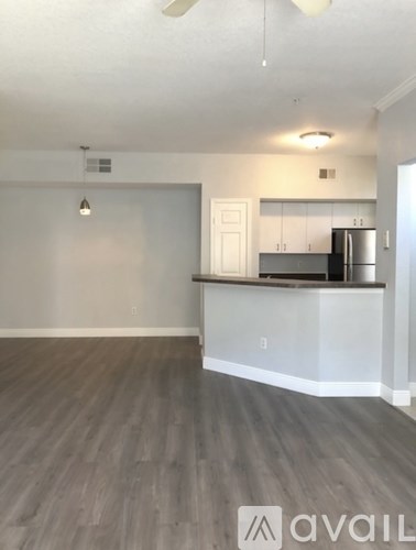 A kitchen area with a refrigerator and cabinets.