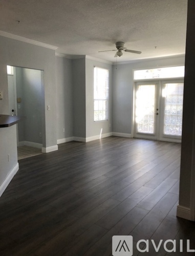 A room with wooden flooring and a ceiling fan.