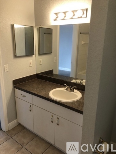 A bathroom with a sink and mirrors.