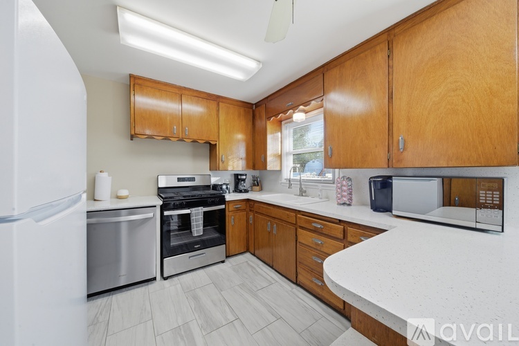 A kitchen with wooden cabinets and a white countertop.