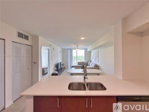 A modern kitchen with a white countertop and wooden cabinets.