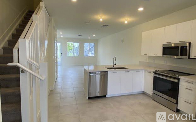 A kitchen with white cabinets and stainless steel appliances.