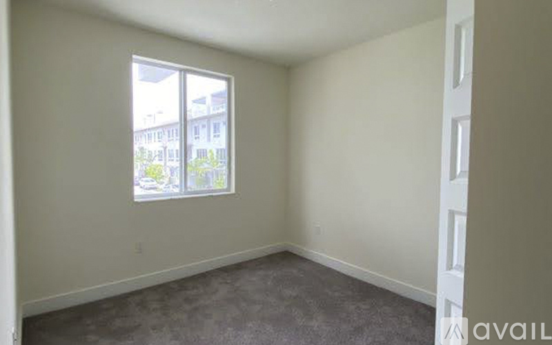 Empty room with a window showing an outdoor view.