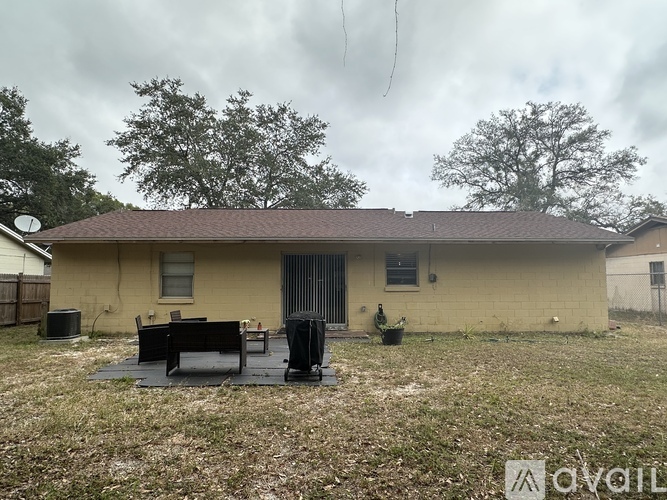A house with a brown roof and a small porch.