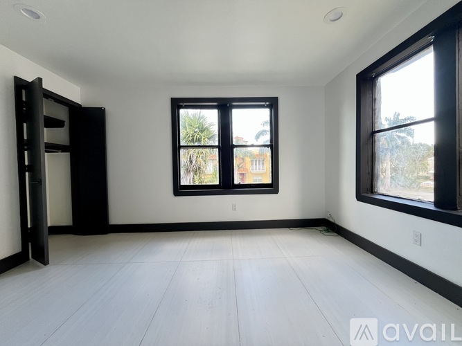 A room with a large window and a door.