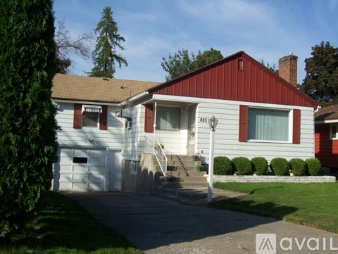 A house with a red and white exterior and a brown roof.