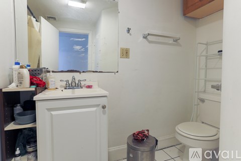 A bathroom with a white toilet and a white sink.