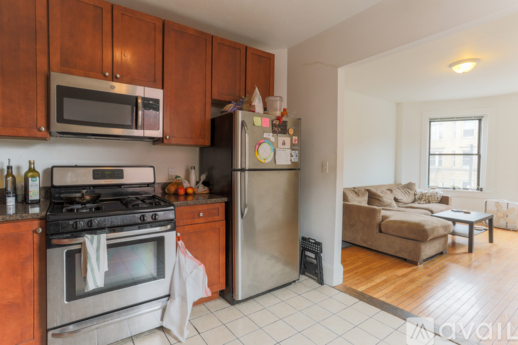 A kitchen with a stove, refrigerator, and cabinets.