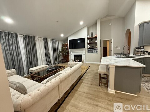 A modern living room with a white sofa and a television.