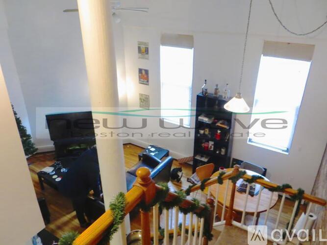 A living room with a couch, a chair, a table, a television, and a bookshelf.