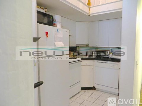 A kitchen with white cabinets and appliances is available for rent.