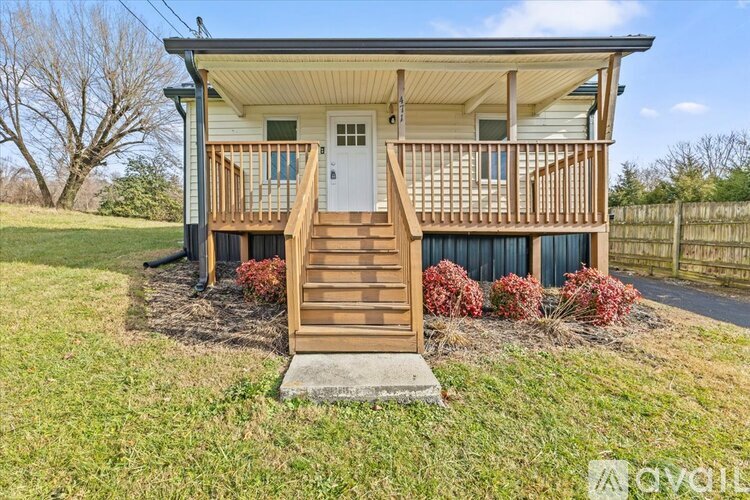 A house with a white door and a wooden porch.