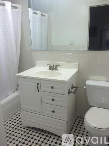 A white bathroom with a sink, toilet and bathtub.