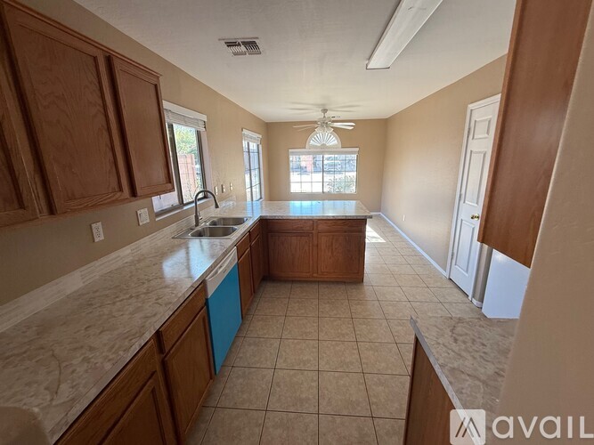 A kitchen with wooden cabinets and a marble countertop.