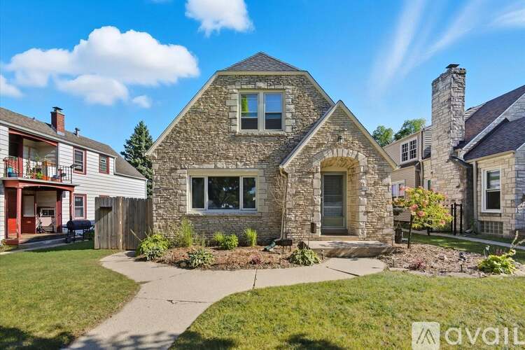 A house with a stone facade and a chimney is for sale.