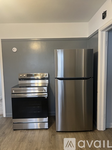A kitchen with a stainless steel refrigerator and an oven.
